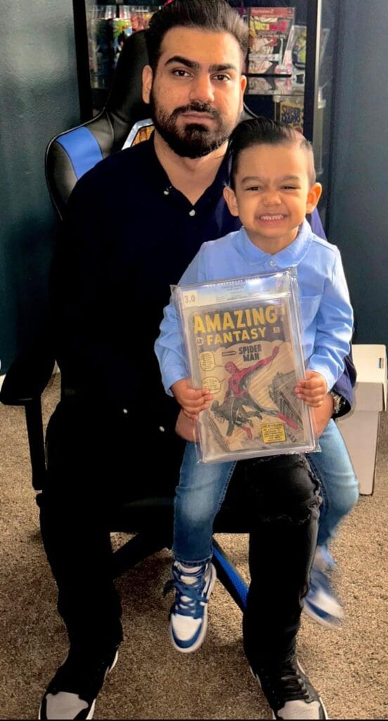 Gabe, owner of EZ Comic Buyer in Southern California, with his son who is holding a rare CGC 3.0 Amazing Fantasy #15 (1962), the first appearance of Spider-Man. They are a local family-owned comic buyer.