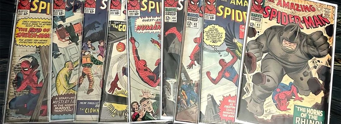 Collection of vintage The Amazing Spider-Man comic books in protective sleeves, featuring key issues like number 41 and 50